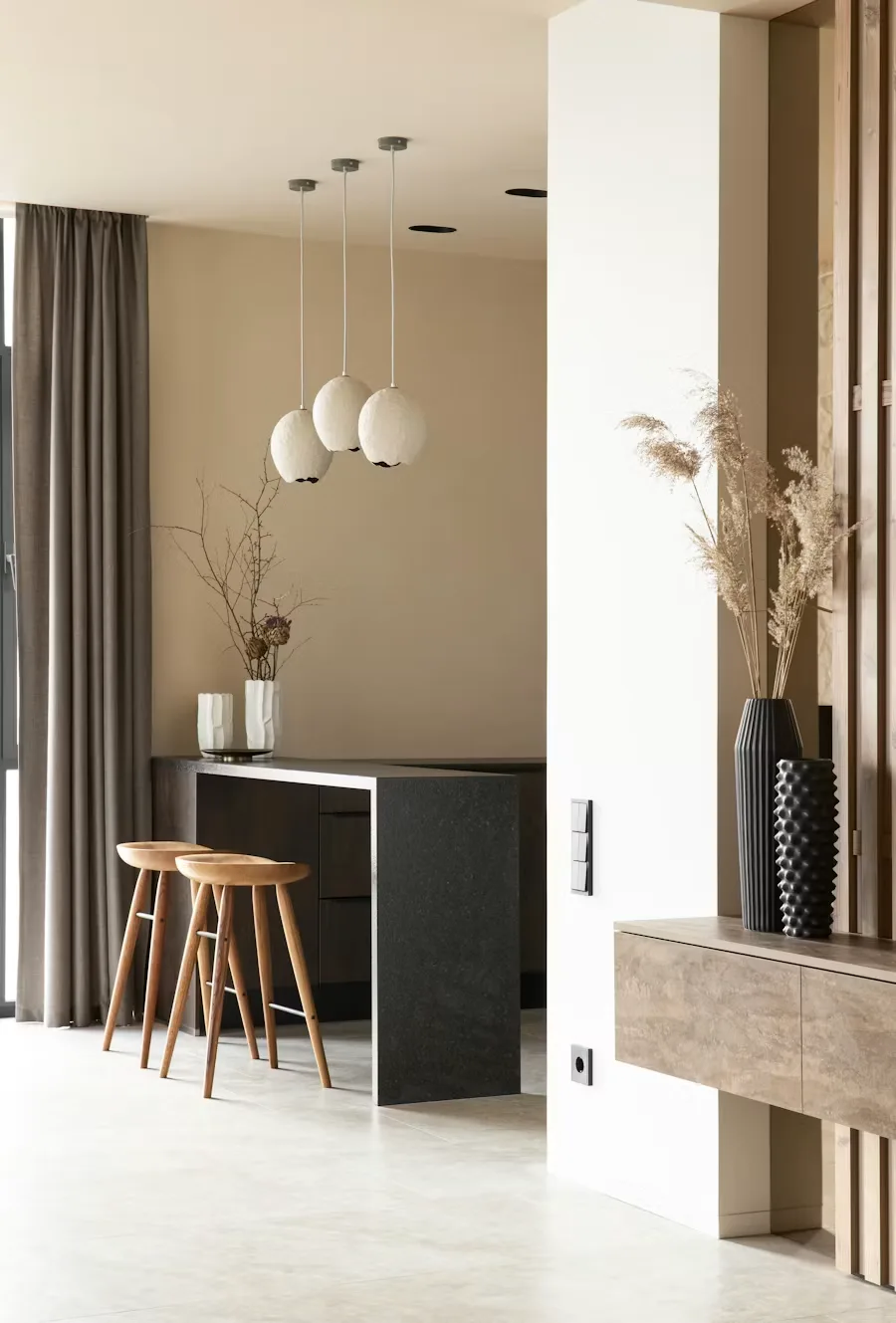 Sunken sofa seating and a coffee table beside an open kitchen in ZEF LIVING’s Rumah Nanta project